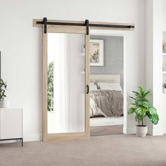 an open sliding door in a bedroom with a bed and potted plant next to it