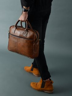 The Laurent leather laptop bag is a true work of art, an exquisite blend of craftsmanship and style. Its supple ebony leather flows with the grace of a waterfall, caressing every contour with an air of opulence. Every stitch is a whisper of meticulous care, a testament to the artistry within. This brown bag transcends mere accessory, embodying an ode to elegance that cocoons your laptop in a realm of refined opulence. Features: Material: Full-grain buffalo leather Expertly handcrafted by skilled Luxury Leather-lined Satchel Briefcase, Luxury Cognac Briefcase With Luggage Sleeve, Luxury Soft Leather Briefcase With Top Handle, Modern Textured Leather Shoulder Bag Briefcase, Modern Textured Leather Shoulder Briefcase, Luxury Cognac Laptop Bag For Office, Luxury Briefcase With Leather Lining And Shoulder Bag Shape, Timeless Textured Leather Briefcase For Everyday Use, Luxury Textured Leather Satchel For Business Trips