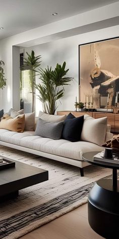 a living room filled with lots of furniture next to a large painting on the wall