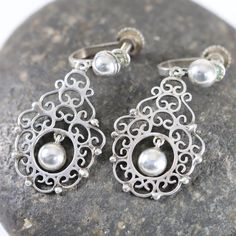 "Silver Ornate Screwback Earrings| Sterling Silver Vintage Jewelry| Handcrafted Experience the enchanting allure of our Sterling Silver Ball and Lace lightweight earrings. Painstakingly handcrafted, these filigree masterpieces radiate enduring femininity. Their intricate design conjures a delightful vintage charm reminiscent of the skilled artisans of early Mexican craftsmanship. Though time may have gently faded the marks, the remnants indicate they were likely marked Mexico and Silver, indicat Vintage Silver Jewelry, Lightweight Earrings, Light Weight Earrings, Screw Back Earrings, Earrings Sterling Silver, Intricate Design, Sterling Earrings, Vintage Charms, Vintage Silver