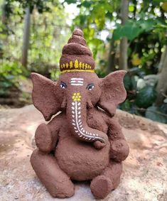 an elephant statue sitting on top of a rock