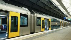 a subway train parked at the station with its doors open