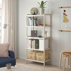 a book shelf with books and magazines on it in the corner of a living room