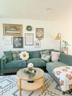 a living room filled with lots of furniture and pictures on the wall above it's coffee table