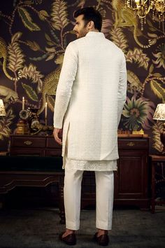 White silk front-open long bundi jacket with cutdana and thread embroidery. - Aza Fashions White Cotton Silk Nehru Jacket For Eid, Eid Chikankari Embroidery Straight Kurta Outerwear, Fitted Off White Nehru Jacket With Chikankari Embroidery, Eid Chikankari Embroidery Straight Kurta, Elegant Cotton Silk Nehru Jacket With Resham Embroidery, Long Nehru Jacket With Naqshi For Festive Occasions, Eid Kurta With Chikankari Embroidery And Front Open Design, Nehru Jacket For Eid Reception Straight Kurta, Winter Nehru Jacket With Resham Embroidery