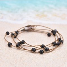 Playfully dainty, our Princess anklets are truly waterproof, unisex & perfect for any occasion. Inspired by our best-selling Princess necklaces, these are the everyday ankle bracelets that take you from the beach to the pool, and back again all summer long. (Beach and pool not necessary for carefree summer vibes!)- 5 black stones- you choose! Snowflake Obsidian, Onyx, or Lava Rock- Signature hand-spun Tula Blue ROPE- 100% waterproof- Loop & puka shell closure- Standard length: 10"One more thing: Princess Necklace, Black Stones, Puka Shell, Versatile Jewelry, Snowflake Obsidian, Shell Bracelet, Lava Rock, Brand Ambassador, Black Stone