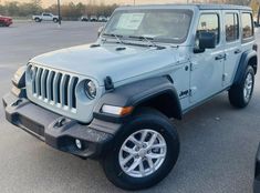 a gray jeep parked in a parking lot