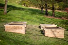 two wooden benches sitting on top of a lush green field