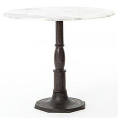 a white marble top table with black metal base and an iron post on the bottom