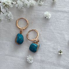 Turquoise Gold Encased Drop Earrings  ☾ ﾟ｡⋆ Details ⋆｡ ﾟ☾ Stone size: Approximately 1cm This listing is for one pair of earrings. The turquoise stones are excellent quality and absolutely stunning. Please note, the stones are organic in shape, as each is charmingly unique, she size and shape of each stone may vary. ☾ ﾟ｡⋆ How to care for your jewellery ⋆｡ ﾟ☾ Although our jewellery is made of high quality materials made to last, to ensure longevity we recommend the following care tips: ● Avoid showering, swimming, and exercising with our pieces ● Polish your pieces every 2 weeks or so, to increase shine and reduce discoloration ● Avoid wearing perfumes with your jewelry ● When not in use, store items in the pouch included in the order ☾ ﾟ｡⋆ Your future awaits ⋆｡ ﾟ☾ In every order, we include Elegant Handmade Turquoise Hoop Earrings, Elegant Turquoise Hoop Earrings, Nickel-free Turquoise Earrings For Gift, Turquoise Earrings With Ear Wire For Gift, Turquoise Hoop Earrings As A Gift, Turquoise Hoop Earrings For Gift, Blue Dangle Earrings As A Gift For Her, Blue Drop Earrings As Gift For Her, Elegant Nickel-free Turquoise Hoop Earrings