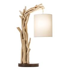 a table lamp made out of driftwood with a white shade on the top and bottom