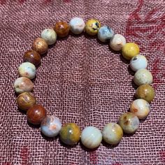 As You Adorn Yourself With The Crazy Lace Agate Bead Bracelet, Remember That You Are Not Just Wearing Jewelry; You Are Becoming Part Of Our Story. A Story That Continues To Evolve, Enriched By The Warmth And Kindness Of Our Esteemed Patrons. Together, We Embark On A Journey Of Discovery, And Together, We Create Beauty”One Bead At A Time.Elevate Your Style And Spirit With The Crazy Lace Agate Bead Bracelet, Exclusively Available At Katmandu Trading Company. Immerse Yourself In The Extraordinary, Spiritual Yellow Beaded Bracelets With 8mm Beads, Yellow Casual Jewelry With 8mm Beads, Casual Yellow Jewelry With 8mm Beads, Yellow Round Bead Meditation Bracelets, Yellow Round Bead Bracelets For Meditation, Casual Yellow Beaded Bracelet With 8mm Beads, Casual Yellow Beaded Bracelets With 8mm Beads, Yellow Gemstone Beads Bracelet, Yellow Gemstone Beaded Bracelets