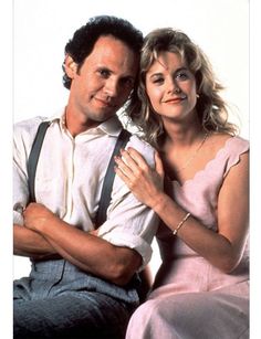 a man and woman sitting next to each other on a white background with their arms around each other