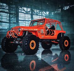 an orange jeep parked in front of a building