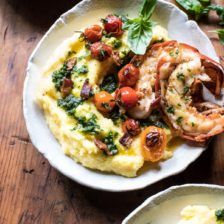 two plates with shrimp and grits on them