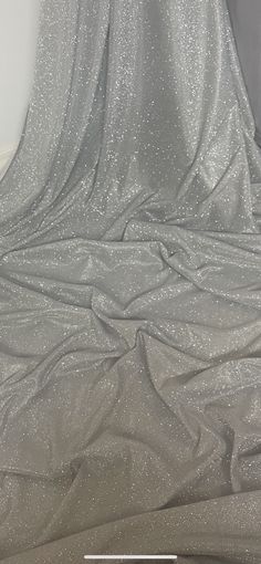 "WHITE/SILVEE MOONLIGHT GLITTER STRETCH FABRIC Product information 1 mtr white/silver moonlight glitter stretch fabric 58\" wide 147cm Moonlight fabrics are a excellent stunning material that is perfect to create beautiful stylish garments. Moonlight material is a sheer fabric with a eye catching sparkle effect that will make up to a beautiful evening wear creations such as skirts and blouses. Ideal for decorations,dress making,bridal,over laying fabric,waistcoats,jackets,table runners,crafts, d Fitted Silver Sequin Fabric With Shimmer, Stretch Sequin Fabric With Shimmer For Evening, Silver Glitter Sequin Fabric For Party Season, Silver Glitter Sequin Fabric For Party, Elegant Silver Sequin Fabric With Glitter, Moonlight Dress, Crushed Velvet Fabric, Bridal Fabric, Silver Fabric