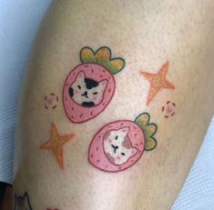 a close up of a person's legs with tattoos on them and cats in donuts