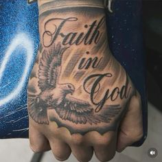 a man with a tattoo on his hand that says faith in god and an eagle