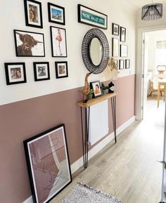 a hallway with pictures and frames on the wall