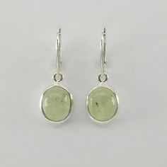 This is a  beautiful pair of green Prehnite Earrings in 925 Sterling Silver. They are made out of Sterling Silver with no nickel so there should be no allergic reaction and nothing will turn green. The silver is not only silver plated or steel but solid 925 Sterling Silver. We usually ship the same in a nice gift box. Green Gemstone Oval Cabochon Earrings, Green Oval Cabochon Gemstone Earrings, Green Cabochon Dangle Earrings, Classic Green Peridot Earrings, Green Peridot Teardrop Earrings, Oval Peridot Earrings For Gift, Nickel-free Oval Green Jewelry, Green Sterling Silver Hallmarked Earrings, Nickel-free Green Oval Jewelry