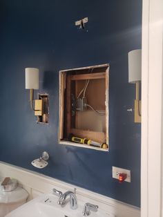 a bathroom that is under construction with blue walls and white trim on the wall,