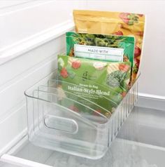 an open refrigerator door with some food in the freezer drawer and other items inside