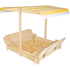 a wooden bed with a yellow and white striped canopy over it's headboard