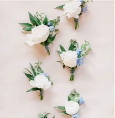 wedding bouquets arranged on the wall with blue and white flowers in each one's boutions