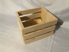 a wooden crate sitting on top of a white sheet