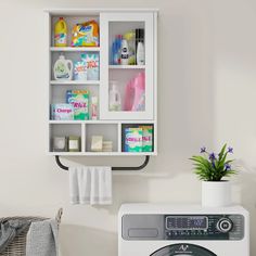 a white washer sitting next to a dryer on top of a laundry machine