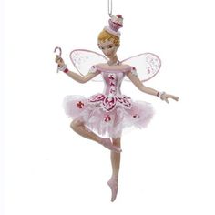 a christmas ornament with a fairy on it's side and a ballerina holding an umbrella