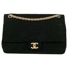 Chanel - Black quilted jersey bag with gold metal attributes. Additional information: Dimensions: Height: 18 cm, Length: 27 cm, Depth: 7 cm, Handle: 63 cm Condition: Good condition Seller Ref number: S214 Chic Black Shoulder Bag With Gold-tone Logo Plaque, Classic Black Bag With Gold-tone Logo Plaque, Designer Black Quilted Flap Bag, Designer Quilted Black Flap Bag, Classic Gold Quilted Bag, Designer Quilted Gold Shoulder Bag, Classic Quilted Gold Bag, Gold Quilted Formal Bag, Gold Quilted Bag For Formal Occasions