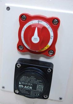 a red and white meter mounted to the side of a wall next to a power outlet