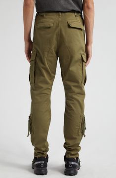 Crafted from heavyweight stretch twill that offers easy-moving comfort, these slim-fitting cargo pants have reinforced knees and a bevy of practical pockets. 31" inseam; 13" leg opening; 13" front rise; 16" back rise (size Medium) Zip fly with button closure Front slant pockets; cargo bellows pockets; cargo utility pockets; back flap pockets Drawstring cuffs 95% cotton, 5% polyurethane Machine wash, dry flat Imported Designer Clothing Techwear Cotton Cargo Pants With Flap Pockets, Military Style Relaxed Fit Cargo Pants With Flap Pockets, Khaki Techwear Cargo Jeans With Pockets, Tactical Cargo Pants With Cargo Pockets For Streetwear, Techwear Cargo Pants With Flap Pockets, Military Cargo Pants With Belt Loops For Outdoor, Urban Cargo Pants With Flap Pockets For Outdoor, Tactical Cargo Jeans For Outdoor, Urban Style Tapered Leg Cargo Pants With Belt Loops