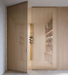 the wine rack in the room is made out of wood and has vertical slats