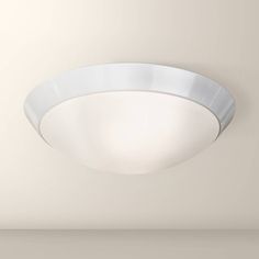 a white ceiling light in a room with no one around it on the wall or floor