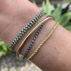 dark green and cream luster seed bead bracelet strung on elastic please gently roll on and off to prolong its life handmade in venice, ca Seed Bead Bracelet, Seed Bead Bracelets, Bead Stringing, Bracelet Handmade, Roll On, Bead Bracelet, Stretch Bracelet, Seed Bead, Delicate Bracelet