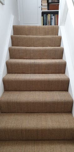 a set of stairs leading up to a bookshelf