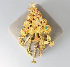 Whimsical Christmas Tree brooch by Kirks Folly, a gardener's delight. It is loaded with flower blossoms, butterflies, dragonflies, bees and ladybugs accented with peach and green enamel.  Small aurora borealis chatons add a bit of extra magic. Length:  3  3/4 inches Width:     1  7/8 inches In excellent condition! Gold Holiday Brooch Jewelry, Whimsical Christmas Tree, 1980s Jewelry, Whimsical Christmas Trees, Kirks Folly, Peach And Green, Whimsical Christmas, Garden Lovers, Green Enamel