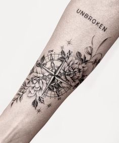 a person with a compass tattoo on their arm