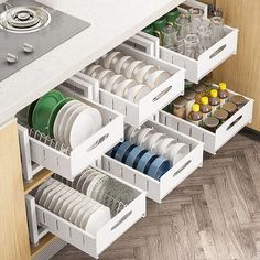 an open drawer in a kitchen filled with dishes