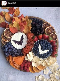 a platter filled with fruit and crackers