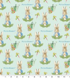 a blue fabric with rabbits and carrots on it