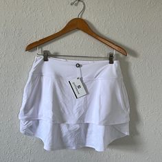 New With Tags Footjoy Layered Golf Skort. Never Worn. Size Medium. White Sports Skirt For Summer, White Sport Skirt For Summer, White Sporty Mini Skirt For Summer, White Tennis Skirt With Built-in Shorts For Summer, White Athleisure Short Skirt, White Short Athleisure Skirt, White Tennis Skirt For Summer, White Athleisure Mini Skirt For Summer, Skirted Tennis Shorts For Summer