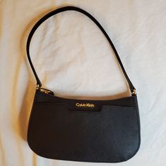 New Calvin Klein Black On My Corner Saffiano Demi Bag New With Tags Color: Black Size: Demi (Small) Measurements: 16-In (L) X 10-In (W) X 7-In (D) Material: Saffiano Leather Zip Closure Exterior: 1 Pocket Interior: 2 Front Pockets, 1 Back Pocket Shoulder Strap Gold-Tone Hardware Style: H6jh15uf Feel Free To Ask Questions Or Make Me An Offer :) Calvin Klein Tote Bag, Tan Shoulder Bag, Calvin Klein Bags, Calvin Klein Bag, Patent Leather Handbags, Over The Shoulder Bags, Brown Purses, Leather Hobo Bag, Black Shoulder Bag