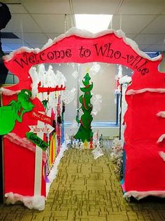 an office decorated for christmas with santa clause and grin the cat in the hat on the door