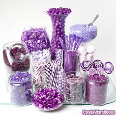 an image of purple and white candy items on a glass table with the words candy warehouse below it