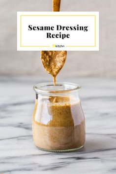 sesame dressing recipe in a glass jar with a wooden spoon sticking out of the jar