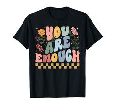 a black t - shirt that says you are enough with flowers and butterflies on it