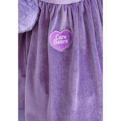 the back of a child's purple dress with a heart on it that says care bears